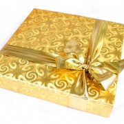 book gift wrapped in gold paper and bow