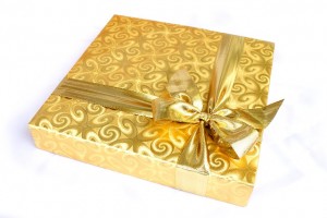 book gift wrapped in gold paper and bow